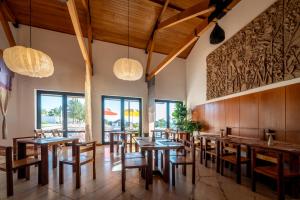 a dining room with wooden tables and chairs at Calipo in Vila Viçosa