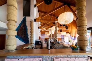a lobby with wooden ceilings and stone columns at Calipo in Vila Viçosa