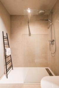 a shower with a glass door in a bathroom at Lets Go Raversijde in Ostend
