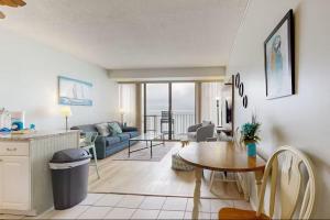 a living room with a table and a couch at Relaxing Oceanfront 2BR Beach Condo! Royal Garden 1514 in Myrtle Beach