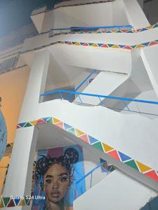 a wall with a painting of a woman on it at Mostafa Jamaica guesthouse in Aswan