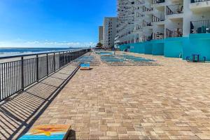 a brick walkway next to the beach with buildings at Relaxing Oceanfront 2BR Beach Condo! Royal Garden 1514 in Myrtle Beach