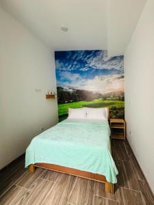 a bedroom with a bed with a painting on the wall at Jardinhabs - JARDÍN in Filandia +21 photos