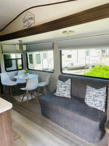a living area of a rv with a couch and a table at 2 BR/2 BA Oasis Kayakes, Pool, Beach & Dock Rental in Key Largo
