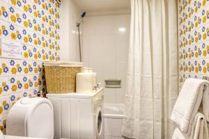 a bathroom with a toilet and a shower at Aida's Place, a Home in Madeira in Ilhéu do Gorgulho +23 photos