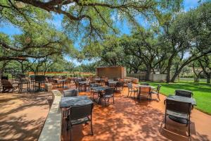 a patio with tables and chairs in a park at The Hills Quiet Spacious Gated Community with Pool! in The Hills