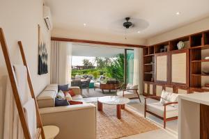 a living room with a couch and a table at Ocean View Villa G32 in Ixtapa-Zihuatanejo International