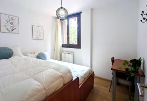 a bedroom with a bed and a desk and a window at Pacino views l wifi l garaje l terraza l vistas in Sallent de Gállego