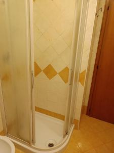 a shower with a glass door in a bathroom at Appartamento la Madonnina in Besenello +4 photos