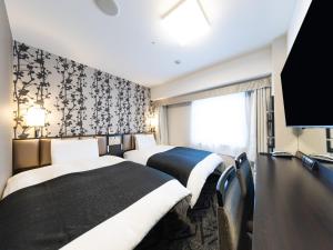 a hotel room with two beds and a tv at APA Hotel Tennoji Ekimae in Osaka +38 photos