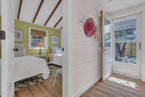 a bedroom with a bed and a door with a window at Hot Tub 3BR Lavallette Girls Trip at the Beach in Monterey Beach