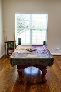 a table in the middle of a room with a window at Luxury Event and Stay in Celina, Texas in Gunter