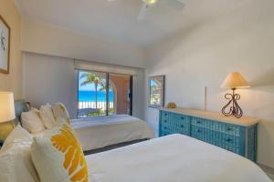 a bedroom with two beds and a view of the ocean at Beachfront Condo at Casa del Mar in El Bedito