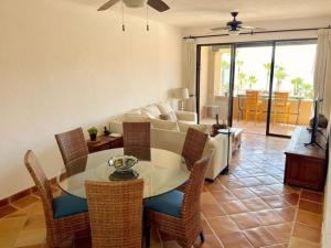 a living room with a table and chairs and a couch at Oceanview Penthouse Casa Del Mar in San José del Cabo
