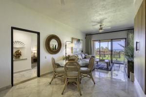 a living room with a table and chairs and a bedroom at Beautiful Beachfront Condo With Spectacular Views in El Bedito
