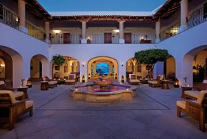 a lobby with a fountain in the middle of a building at Gorgeous Casa del Mar Condo in Cabo San Lucas