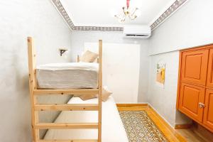 a bedroom with a bunk bed and a ceiling at Bubbly Hostel Marrakech in Marrakech