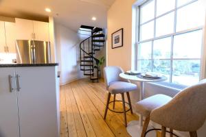 a kitchen with a table and chairs in a room at Habour Haven minutes from downtown Mystic in Mystic