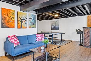 a living room with a blue couch and a table at Completely Renovated Home in St. Charles, Missouri in Harvester