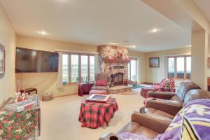 a living room with a couch and a fireplace at On the lake Hot Tub Pool Table 10 Beds in Cokato