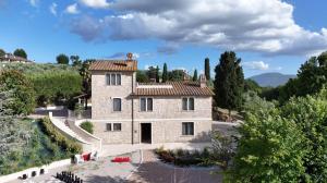 an aerial view of a stone house with trees at Umbriance Villa con piscina privata in Stroncone
