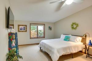 a bedroom with a bed and a ceiling fan at On the lake Hot Tub Pool Table 10 Beds in Cokato