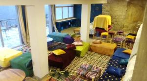 a room with many different colored pillows and chairs at Refuge AIT M'HAMED in Aït Mehammed +58 photos