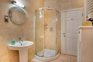 a bathroom with a shower and a sink at Taylors Beadnell House Apts in Beadnell +10 photos