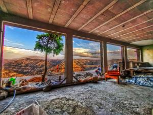 a room with large windows with a view of the grand canyon at Refuge AIT M'HAMED in Aït Mehammed