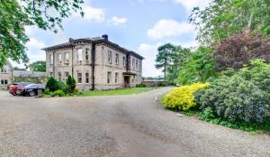 an old house with a car parked in front of it at Taylors Beadnell House Apts in Beadnell