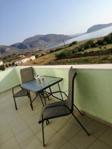 a table and a chair on a balcony with a view at Locanda in Monemvasia