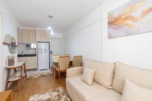 een woonkamer met een bank en een keuken bij Apartamento de 1 Quarto com Sofa-Cama - CEN1104 in Curitiba
