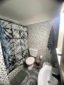 a bathroom with a toilet and a sink at Olivos Stay in Olivos