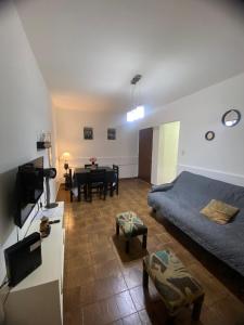 a bedroom with a bed and a living room at Olivos Stay in Olivos