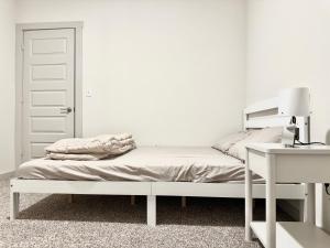 a white bedroom with a bed and a desk at Peaceful Room in Austin in Austin