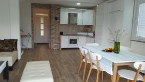 a kitchen and dining room with a table and chairs at Zem Zem kuća za odmor in Otoka