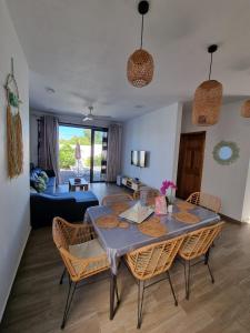 a living room with a table and chairs and a couch at Marbella villas 2 in Grand Baie