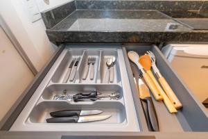 a drawer in a kitchen with utensils in it at Estúdio Completo para 4 Pessoas no Eixo - EIX0201 in Curitiba +51 photos