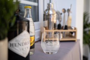a bottle of wine and a glass on a table at Vila Maria II in Vinkovci