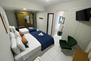 a bedroom with a bed and a tv in it at Eficiência - Casa da Lidu - Vista da Ilha do Amor in Camocim