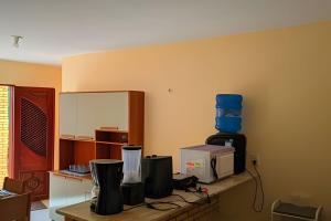 a room with a counter with a microwave and acomputer at Eficiência - Casa São Pedro - Casa Beira Mar in Camocim