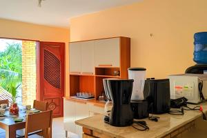 a kitchen with a counter with a blender on it at Eficiência - Casa São Pedro - Casa Beira Mar in Camocim