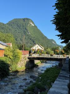 a bridge over a river with a mountain in the background at Pyrenees family T3 in Aulus-les-Bains