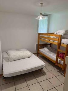 a room with two bunk beds and a lamp at Pyrenees family T3 in Aulus-les-Bains +21 photos