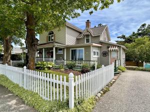 a white picket fence in front of a house at Lady Mary Angeline in Saint Ignace