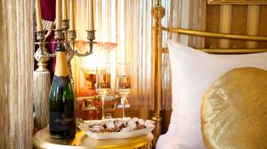 a table with a bottle of champagne and a bowl of nuts at Sultan Suites Hotel in Istanbul +59 photos