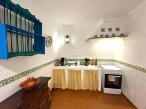 a kitchen with a table in the middle of it at Casa Isabel - La Almona Chica in El Chorro