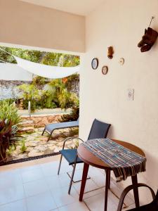 a room with a table and chairs and a patio at Casa Chaak Maya - Estudio privado con alberca en Mérida in Mérida