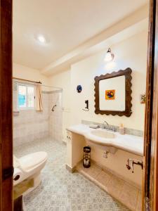 a bathroom with a toilet and a sink and a shower at Casa Chaak Maya - Estudio privado con alberca en Mérida in Mérida