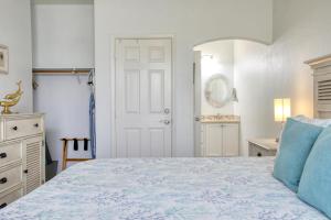 a bedroom with a bed with a blue comforter at Pacific Plaza #608 - Oceano Getaway - 1BdrmUp-K-QSofa in Oceano +33 photos